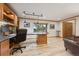 Office featuring custom built-ins, modern lighting, hardwood floors, and a view to the outside at 11796 W 53Rd Pl, Arvada, CO 80002