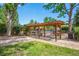 Tranquil gated community pool area with pergola, mature trees, and seating for residents to enjoy at 11796 W 53Rd Pl, Arvada, CO 80002