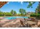 Community pool with ample seating, lounge chairs, and umbrellas perfect for hot summer days at 11796 W 53Rd Pl, Arvada, CO 80002