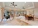 Bright sun room with tile floors, large windows, ceiling fans, and comfortable seating at 11796 W 53Rd Pl, Arvada, CO 80002