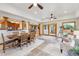 Bright sun room with tile floors, large windows, ceiling fans, and comfortable seating and dining space at 11796 W 53Rd Pl, Arvada, CO 80002