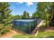 Well-maintained community tennis court surrounded by trees, offering a private and enjoyable recreation space at 11796 W 53Rd Pl, Arvada, CO 80002