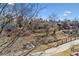 Picturesque backyard view with walking path and wooden bridge, offering a peaceful outdoor experience at 7696 S Monaco E Cir, Centennial, CO 80112