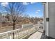Charming balcony with white railing and a planter box, offering serene views of the surrounding landscape at 7696 S Monaco E Cir, Centennial, CO 80112