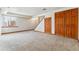 Spacious carpeted basement area with natural light and a large storage closet with wood doors at 7696 S Monaco E Cir, Centennial, CO 80112