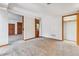Large carpeted room with closet, storage and an entrance to the bathroom at 7696 S Monaco E Cir, Centennial, CO 80112