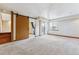 Spacious carpeted room with sliding barn door, a sliding glass door and a window at 7696 S Monaco E Cir, Centennial, CO 80112