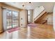 Living area with wood floors, a staircase, and sliding glass doors at 7696 S Monaco E Cir, Centennial, CO 80112