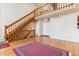 Spacious living room features wood floors, staircase, and natural light at 7696 S Monaco E Cir, Centennial, CO 80112