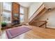 Bright living room features a brick fireplace, wood floors, and a staircase at 7696 S Monaco E Cir, Centennial, CO 80112