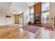 Bright living room features a brick fireplace, wood floors, and large windows at 7696 S Monaco E Cir, Centennial, CO 80112