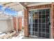 Cozy brick patio area with sliding glass door and secure fencing, perfect for outdoor relaxation at 7696 S Monaco E Cir, Centennial, CO 80112