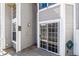 Cozy patio area with sliding glass door and a decorative wall fixture, enhancing outdoor living at 7696 S Monaco E Cir, Centennial, CO 80112
