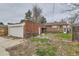 View of backyard with garage and covered back patio at 2866 Bellaire St, Denver, CO 80207