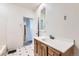 Bathroom with wood vanity, vinyl floors, and a tub at 2866 Bellaire St, Denver, CO 80207