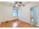 Bedroom featuring hardwood floors, a ceiling fan, and ample natural light from the window at 2866 Bellaire St, Denver, CO 80207