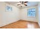 Empty bedroom featuring wood floors and natural light from two windows at 2866 Bellaire St, Denver, CO 80207