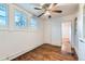 Bedroom featuring hardwood floors, ceiling fan, and two windows at 2866 Bellaire St, Denver, CO 80207