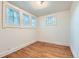 Empty bedroom with hardwood floors and three windows providing natural light at 2866 Bellaire St, Denver, CO 80207