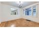 Elegant dining room featuring hardwood floors, natural light and a decorative mirror at 2866 Bellaire St, Denver, CO 80207