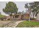 Attractive brick home featuring a covered porch and lush front yard at 2866 Bellaire St, Denver, CO 80207
