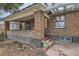 Charming covered front porch, brick columns, and view of house number at 2866 Bellaire St, Denver, CO 80207