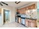Traditional kitchen featuring wooden cabinets, black countertops, and stainless steel appliances at 2866 Bellaire St, Denver, CO 80207