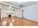 Open living room featuring hardwood floors, fireplace, and ample lighting at 2866 Bellaire St, Denver, CO 80207