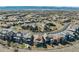 Scenic aerial view of a neighborhood with well-maintained homes and lush green spaces, with mountains in the distance at 10662 Skydance Dr, Highlands Ranch, CO 80126