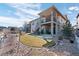 Beautiful backyard featuring a covered deck, patio, and landscaped lawn at 10662 Skydance Dr, Highlands Ranch, CO 80126