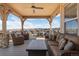 Enjoy breathtaking views from this expansive covered balcony complete with plush seating and ceiling fan at 10662 Skydance Dr, Highlands Ranch, CO 80126