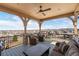 Enjoy breathtaking views from this expansive covered balcony complete with plush seating and ceiling fan at 10662 Skydance Dr, Highlands Ranch, CO 80126