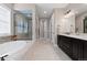 Bright bathroom featuring a soaking tub, walk-in shower, and double vanity at 10662 Skydance Dr, Highlands Ranch, CO 80126