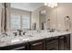 Granite counters accent this bathroom with dual sinks and bronze fixtures at 10662 Skydance Dr, Highlands Ranch, CO 80126