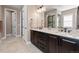 Bathroom with a granite countertop, dual sinks, and a large mirror at 10662 Skydance Dr, Highlands Ranch, CO 80126