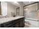Bathroom with a granite countertop, sink, shower and tub combo at 10662 Skydance Dr, Highlands Ranch, CO 80126