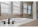 Close up of a white bathtub with a black faucet and a walk-in shower at 10662 Skydance Dr, Highlands Ranch, CO 80126