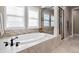 Close up of a white bathtub with a black faucet and a walk-in shower at 10662 Skydance Dr, Highlands Ranch, CO 80126