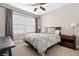 Well-lit bedroom featuring a comfortable bed, nightstands, and large window at 10662 Skydance Dr, Highlands Ranch, CO 80126