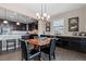 Dining area with dark wood table, chandelier, and built-in cabinets with countertop space at 10662 Skydance Dr, Highlands Ranch, CO 80126