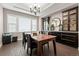 Dining room with dark wood floors, modern lighting fixture, and large window providing natural light at 10662 Skydance Dr, Highlands Ranch, CO 80126