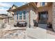 Inviting front patio with stone accents and outdoor seating near the entrance of the home at 10662 Skydance Dr, Highlands Ranch, CO 80126