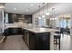 Modern kitchen showcasing dark cabinets, stainless steel appliances, and a spacious center island at 10662 Skydance Dr, Highlands Ranch, CO 80126