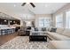 Bright living room with neutral decor, fireplace, and a view of the open kitchen concept at 10662 Skydance Dr, Highlands Ranch, CO 80126