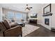 Cozy living room with a fireplace, comfortable seating, and a mounted TV for relaxation at 10662 Skydance Dr, Highlands Ranch, CO 80126