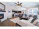 Open-concept living room with a fireplace, plush sofa, and a view of the modern kitchen at 10662 Skydance Dr, Highlands Ranch, CO 80126