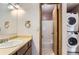 Bright bathroom features a vanity sink, bathtub, and convenient washer/dryer combo, creating an efficient space at 8635 Clay St # 417, Westminster, CO 80031