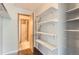 Open closet showcases built-in shelving, hardwood floors, and easy access to the bathroom, offering convenient storage at 8635 Clay St # 417, Westminster, CO 80031