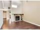 Open living room features a stone fireplace and beautiful hardwood floors, offering an inviting space for gatherings at 8635 Clay St # 417, Westminster, CO 80031