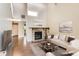 Bright living room features a stone fireplace, hardwood floors, neutral colors, and plenty of natural light at 8635 Clay St # 417, Westminster, CO 80031